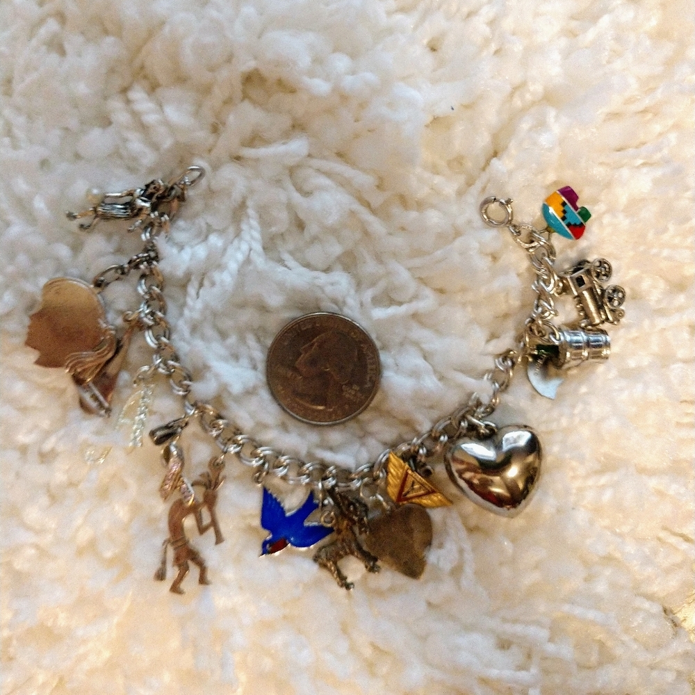Sterling silver charm bracelet full of Ster. charm